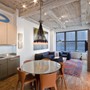 Gramercy Loft - The dining and living room of a Manhattan loft.  The original wood floors and concrete ceiling recall the building's industrial history.