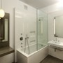 Gramercy Loft - Baldosas blancas sencillas y un piso de hormigón pulido crean un ambiente limpio y sereno.